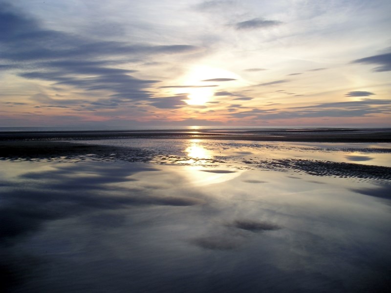 Smokey sunset at low tide